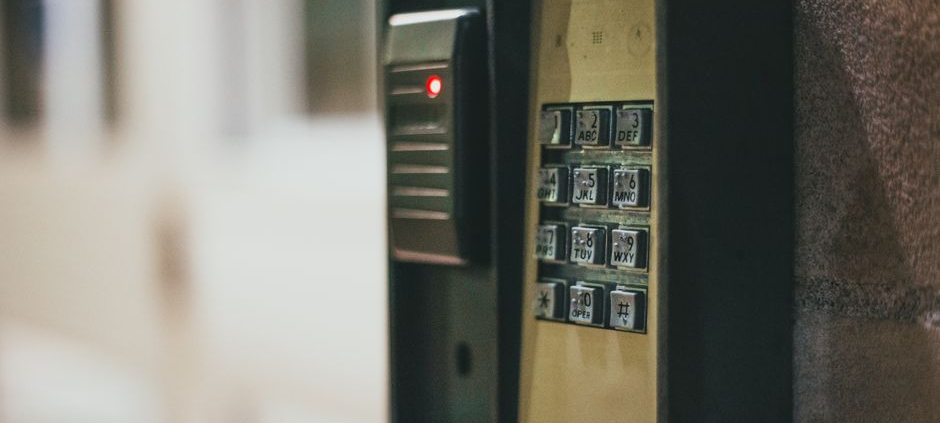 Close-up of a security access control keypad with illuminated buttons for keyless entry.