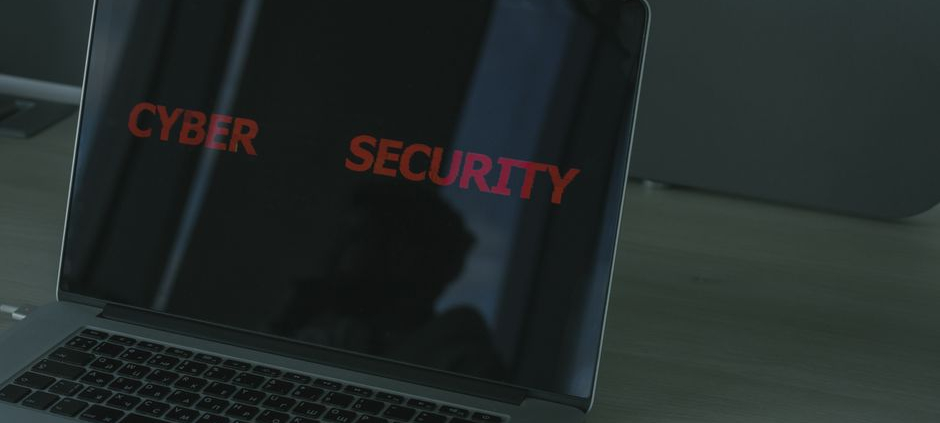 Close-up of a laptop displaying cybersecurity text, emphasizing digital security themes.