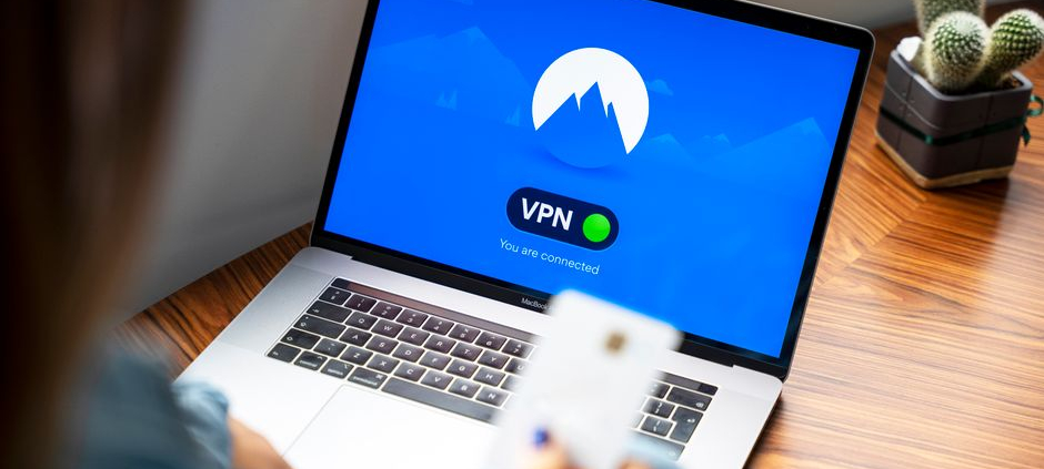 A person using a VPN on a laptop, symbolizing secure internet browsing in a modern indoor setting.
