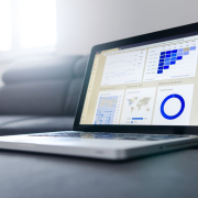 Sleek laptop showcasing data analytics and graphs on the screen in a bright room. Sleek laptop showcasing data analytics and graphs on the screen in a bright room.