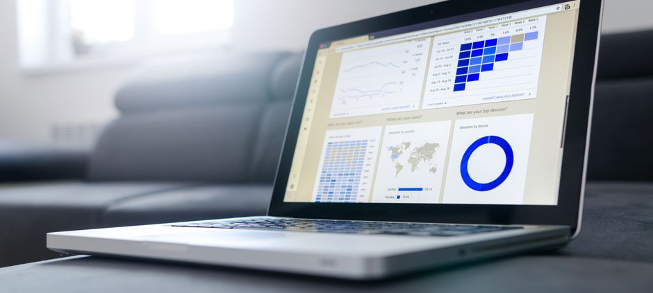 Sleek laptop showcasing data analytics and graphs on the screen in a bright room.